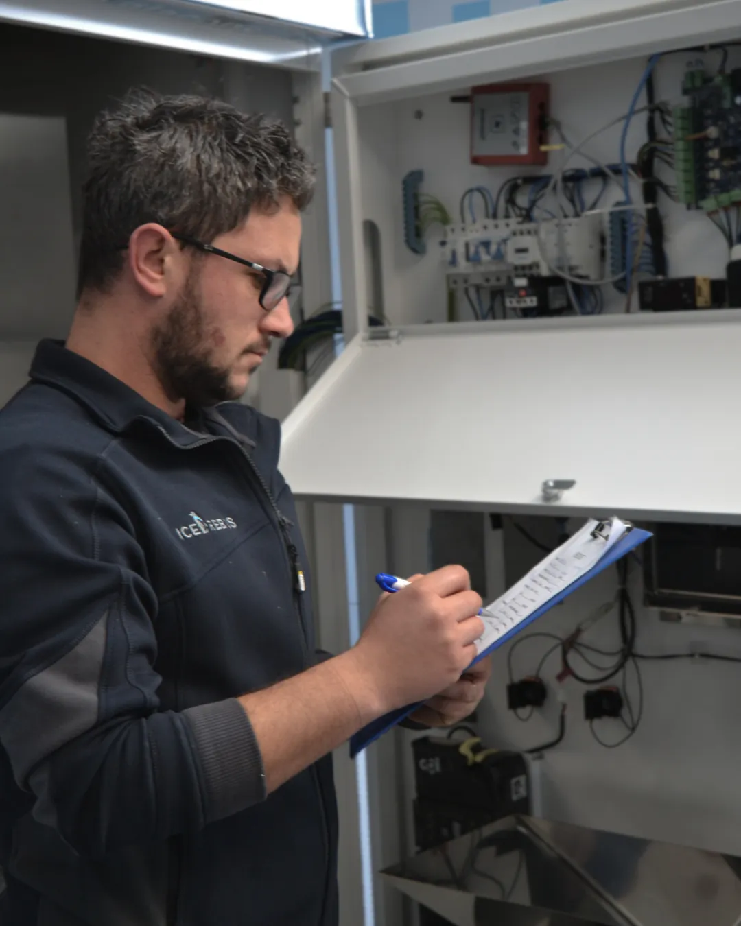 IceRebus technician servicing an intelligent ice vending machine control system